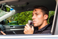 driver taking a drunk driving breath test
