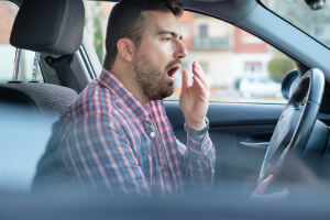 tired male driver yawning