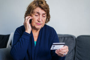 elderly woman calling credit card company