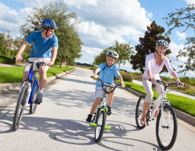 family of cyclists on the road