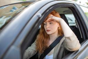 woman looking hypnotized behind wheel