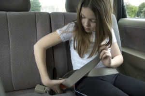 girl fastening seatbelt