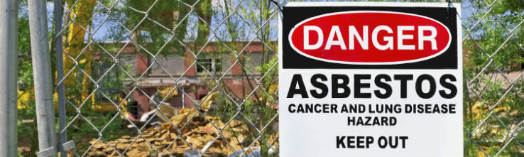 fence with asbestos sign