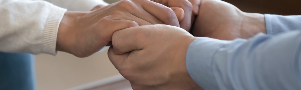 couple holding hands for emotional support