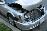 silver sedan with smashed front hood and bumper