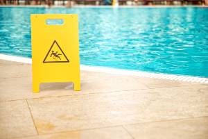 wet floor sign by a pool