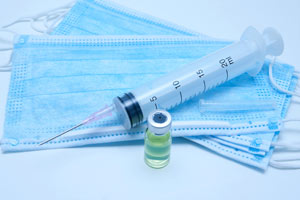 a needle with a bottle of liquid steroids
