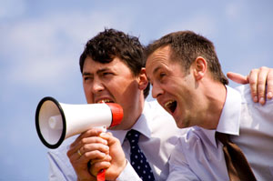 two men talking into a megaphone