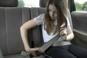 girl fastening seatbelt
